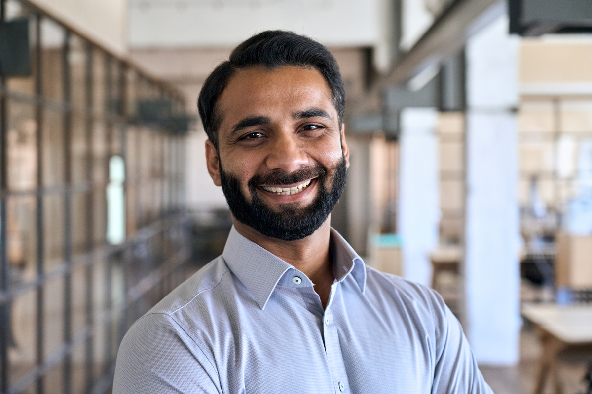 Male Professional with Beard Standing in Office