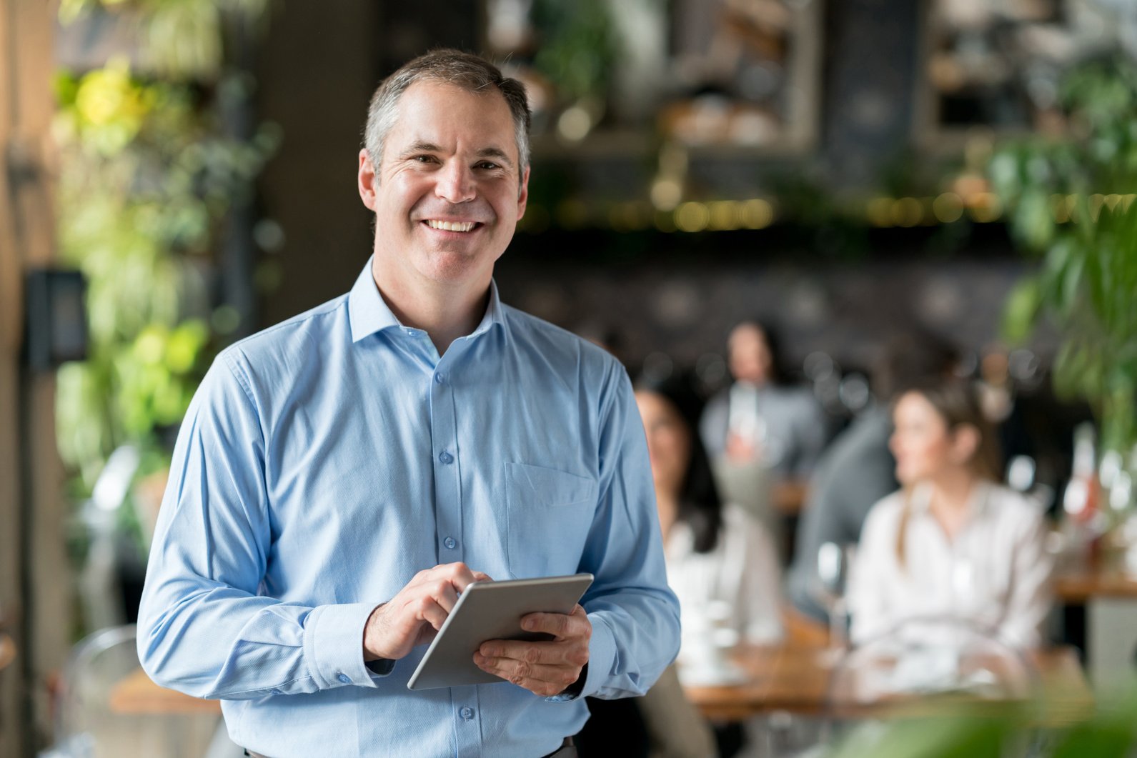 Happy business owner at a restaurant